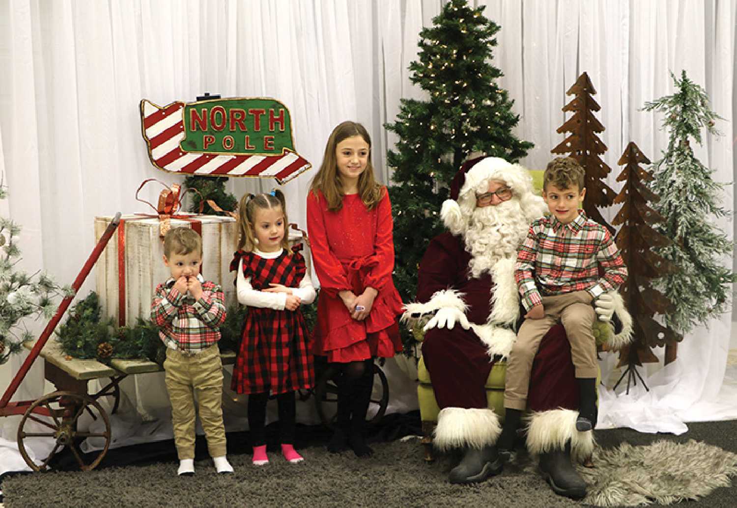 Kids taking pictures with Santa during Santa Day 2022.